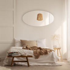 Ovale spiegel in de slaapkamer op de muur